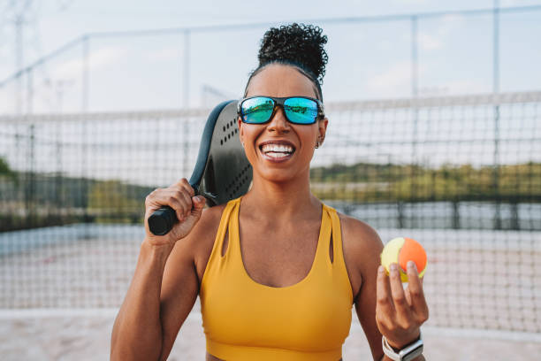 Portrait of a woman playing beach tennis