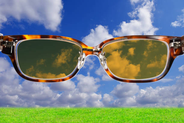 Close up of cloudscape seen through sunglasses with meadow.